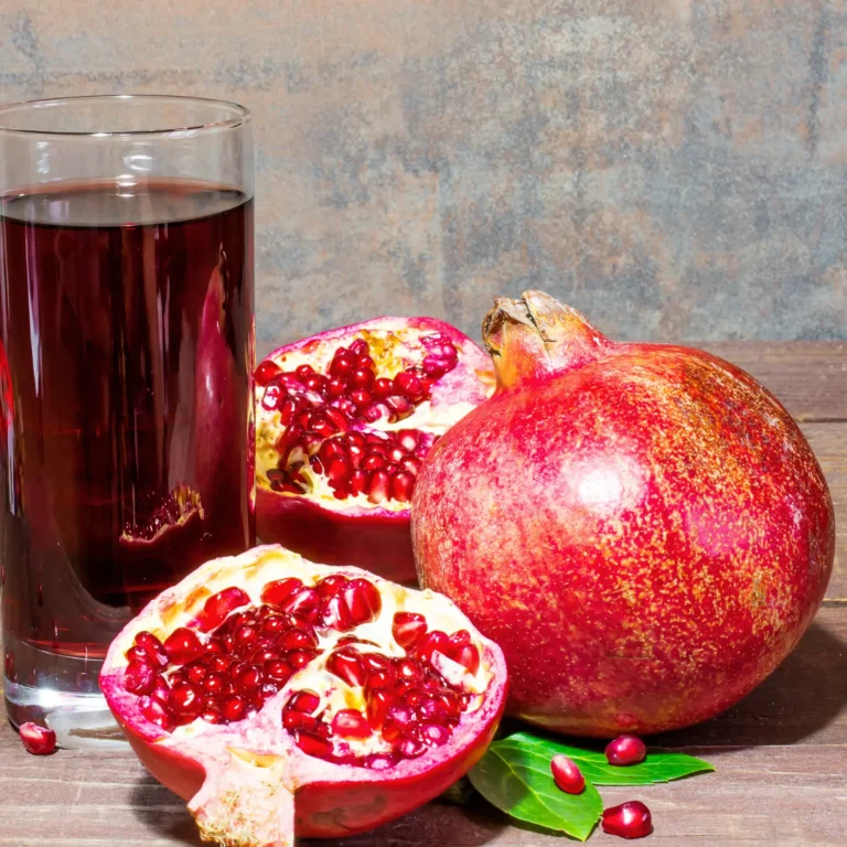 "Pomegranate Juice in a Glass with Fresh Pomegranate Seeds"