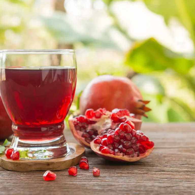 "Glass of Pomegranate Juice with Fresh Pomegranate Seeds"